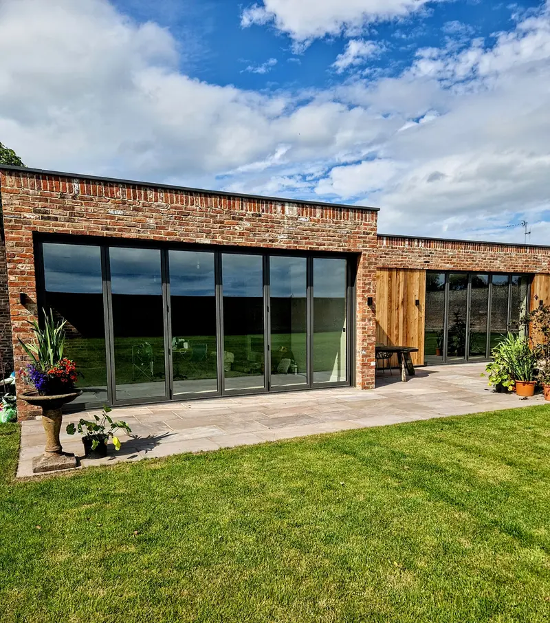 Bifold run in a red brick rear elevation, opened back