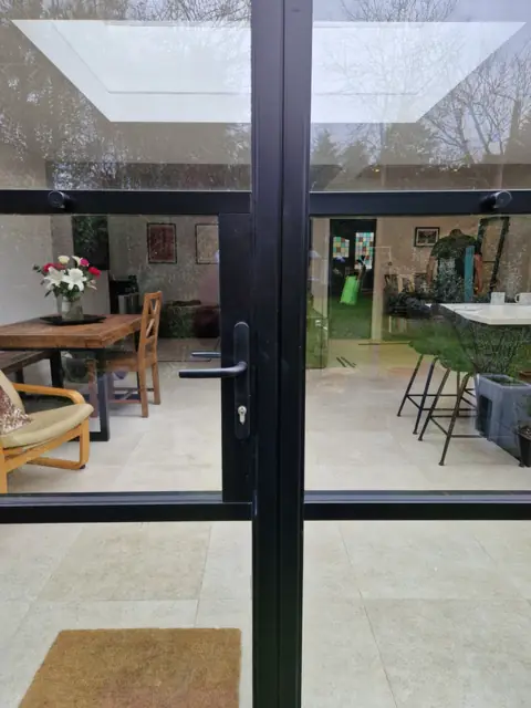 Heritage-bar aluminium door with glazing bars, seen from the patio
