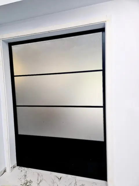 Steel-look internal screen with obscure glazing and horizontal bars, set in a white reveal